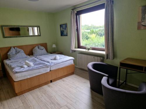 a bedroom with a bed and a large window at Hotel PB in Goslar