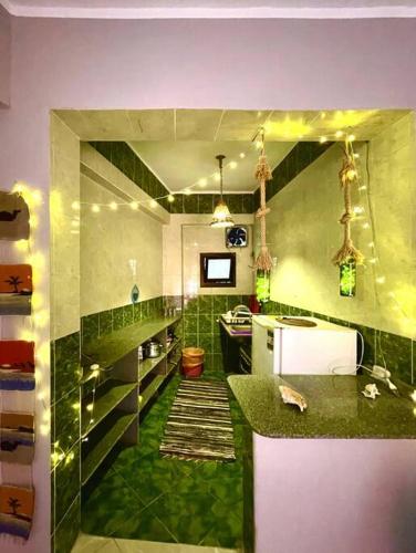 a kitchen with green tiles and a green floor at BohemiaHouse - Duplex By the sea in Dahab