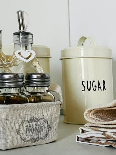 a shelf with bottles of syrup and a can of sugar at SHUBY HOME in San Pietro Vernotico