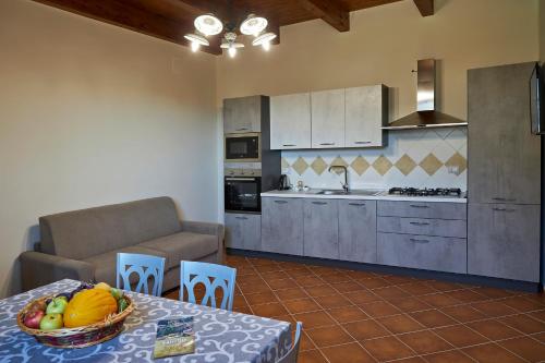 a kitchen with a table with a bowl of fruit on it at Agriturismo ARCE di Monte Acero in Faicchio