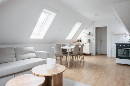 a living room with a couch and a table at Centrum Condo with Terrace in Bergen