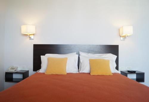 Una cama o camas en una habitación de Morada Sur Apart Hotel