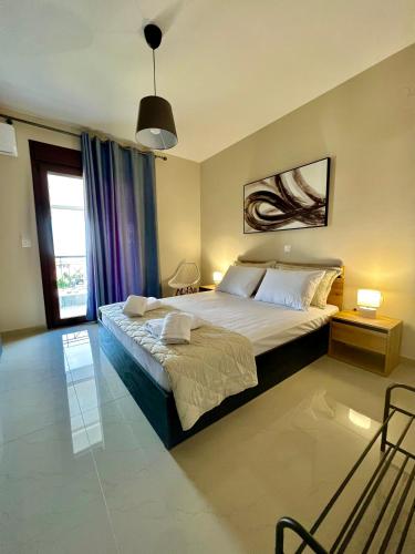 a bedroom with a large bed and a window at Aliki's House in Kalabaka