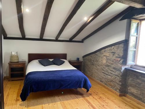 - une chambre avec un lit et une couverture bleue dans l'établissement Casa da Oliveira, à La Corogne