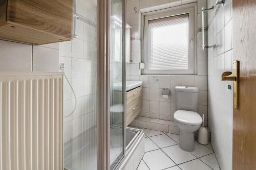 uma casa de banho com um WC e uma cabina de duche em vidro. em Unterkunft mit Balkon in Lünen em Lünen