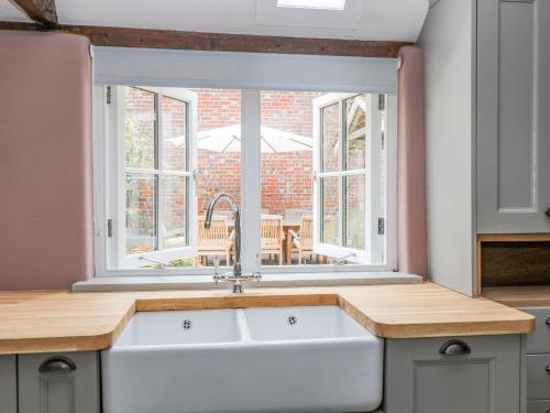 a kitchen with a sink and a window at The Old Bakehouse in Marlborough