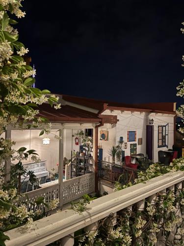 a house with a porch at night at Check Point Hotel in Tbilisi City
