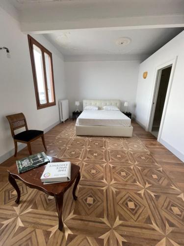 a bedroom with a bed and a table and a coffee table at The B Collection - San Marco Riva schiavoni in Venice