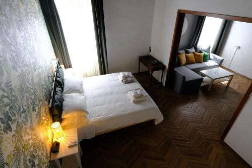 a hotel room with a bed and a couch at Trevi Little Palace #4 in Rome