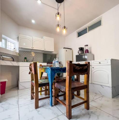 a kitchen with a blue table and chairs at Cozy Apartment 10 min from downtown in San Luis Potosí