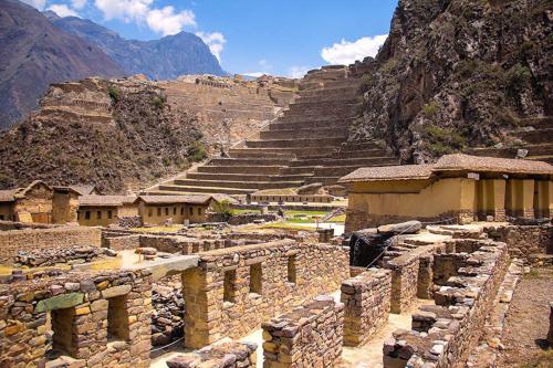 a group of ruins in a mountain with steep steps at traverse peru in Cusco