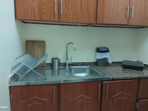 a kitchen with a sink and a counter top at Nice studio for stay .. in Al Ain