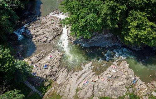 an aerial view of a river with a waterfall at Під горою in Sheshory
