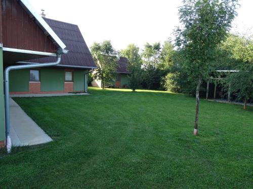 a small tree in a yard next to a house at Penzion Pod Vápenkami in Strážnice