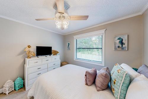 a bedroom with a bed and a tv and a window at Solar Retreat in Spring Hill