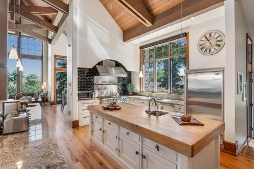 an open kitchen with a large island and a clock on the wall at Chateau at Elk Spring in Edwards