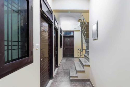a hallway with stairs and a door in a house at OYO Flagship A Hospitality in Lucknow