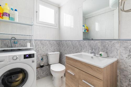 a bathroom with a washing machine and a sink at private room in shared apartment Valencia WorkStay in Valencia