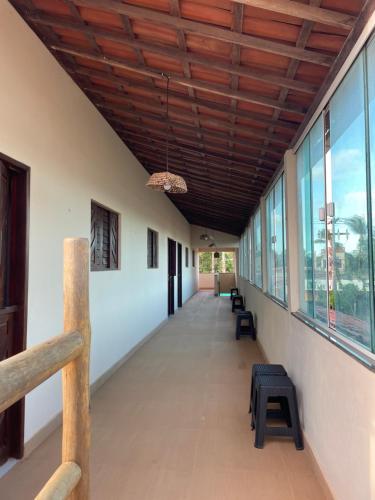 a hallway with windows and a wooden ceiling at Gostoso Maresia Flats in São Miguel do Gostoso