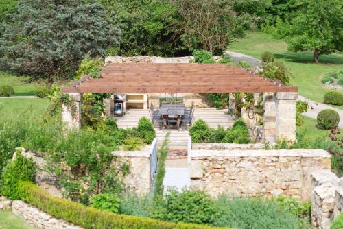 an external view of a stone house with a stone wall at Château Forge du Roy in Mauzens-et-Miremont