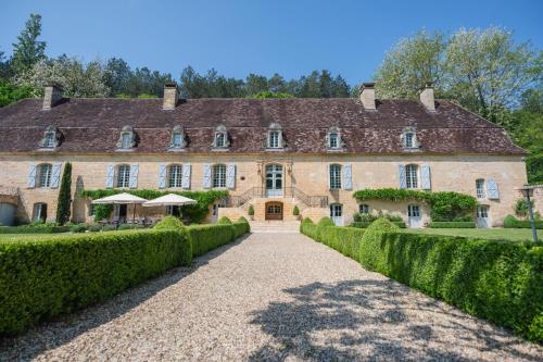 a large stone building with a pathway in front of it at Château Forge du Roy in Mauzens-et-Miremont