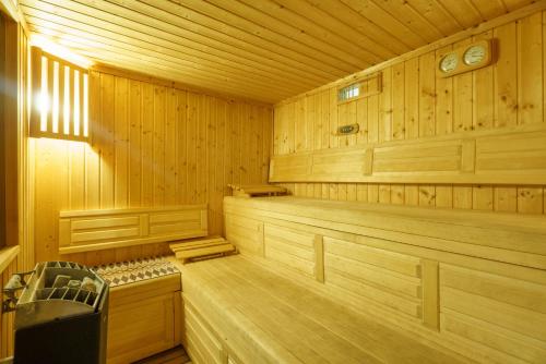 a large wooden sauna with a bench in it at Château Forge du Roy in Mauzens-et-Miremont
