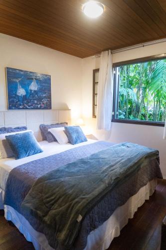 a bedroom with two beds and a large window at Don Pascual in Rio de Janeiro