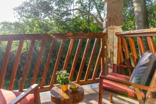 a deck with a chair and a coffee table on a porch at Don Pascual in Rio de Janeiro