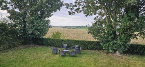 a group of chairs sitting at a table under a tree at Charming Studio Rutland Point holiday or work in Oakham