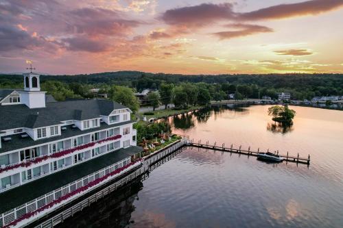 a view of a river with a house and a dock at Mill Falls Resort Collection at the Lake in Meredith