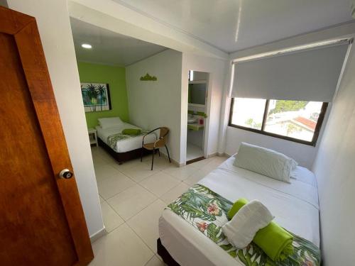 a small bedroom with a bed and a window at La Posada De Lulú in San Andrés