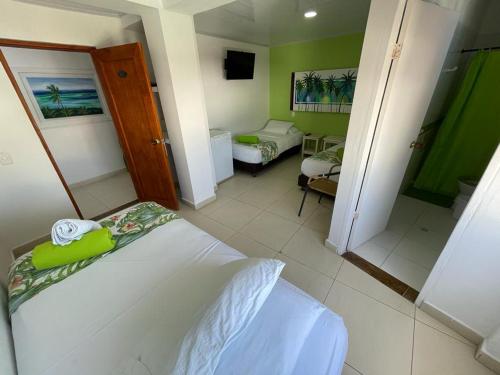 a small room with a bed and a bathroom at La Posada De Lulú in San Andrés