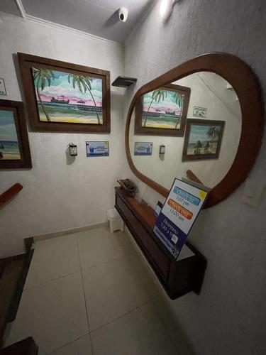 a bathroom with a mirror and a sign on the wall at La Posada De Lulú in San Andrés