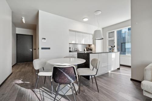 a kitchen and dining room with a table and chairs at Cozy Lux 2BR & 2BA City Center with Free Parking in Reykjavík