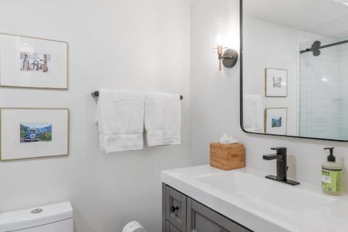 a white bathroom with a sink and a mirror at Boomerang 203 - A Telluride Retreat in Telluride