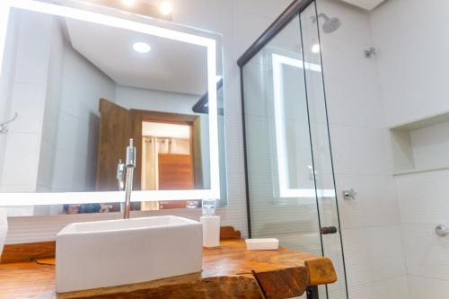 a bathroom with a sink and a mirror at Don Pascual in Rio de Janeiro