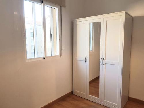 a room with a white cabinet and a window at Piso- Huesca Capital - with elevator in Huesca