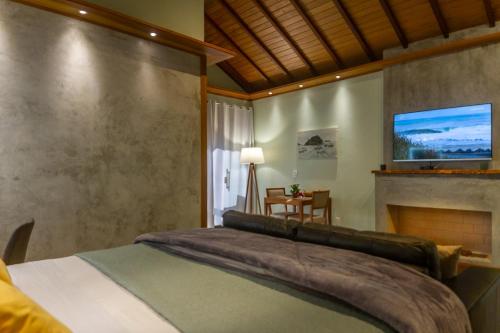 a bedroom with a large bed and a fireplace at Don Pascual in Rio de Janeiro