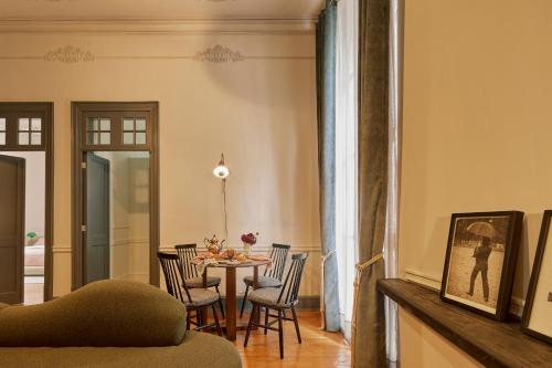 a dining room with a table and chairs at Maison Celeste in Mexico City