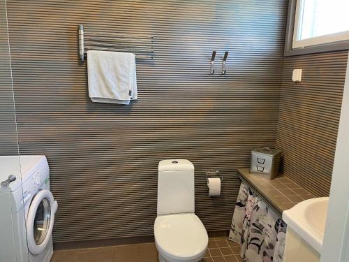 a bathroom with a toilet and a sink at Puuppola Kotikoivu 