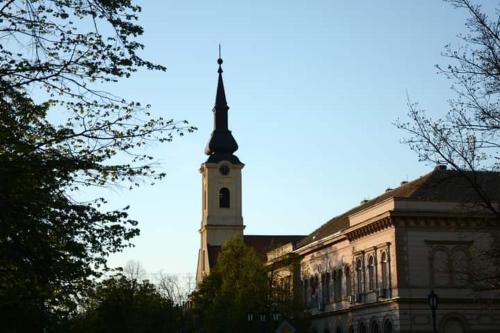 a building with a clock tower on top of it at Apartman studio DUE in Apatin