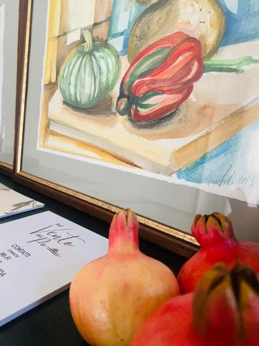 a painting of pomegranates and other vegetables in front of a painting at Sul VenTo del Po in Melara