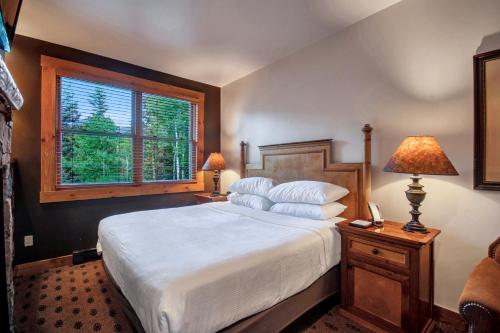a bedroom with a large bed and a window at Mountain Lodge Telluride in Telluride
