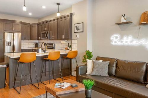 a living room with a couch and a kitchen at Modern condo in the heart of uptown Butte - Unit A in Butte