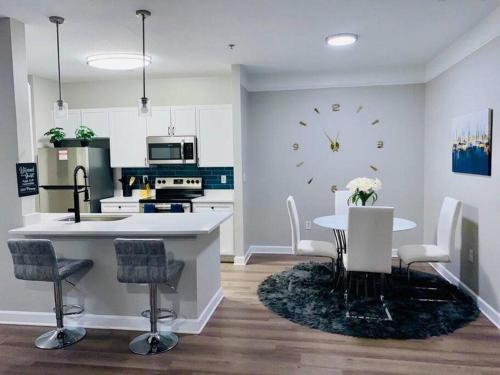 a kitchen with a table and a clock on the wall at Lake Norman Royal Retreat in Mooresville