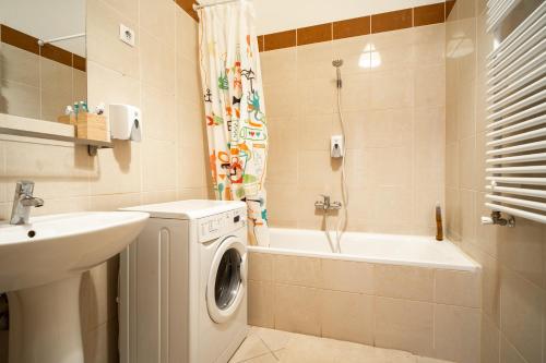 bagno con lavatrice e lavandino di Central Apartment at Gozsdu Court, 60 sqm, 2 Rooms with 2 AC, Elevators, Kitchen a Budapest