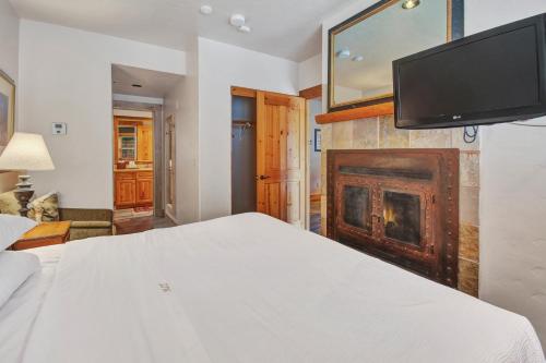 a bedroom with a bed and a fireplace at Mountain Lodge Telluride in Telluride