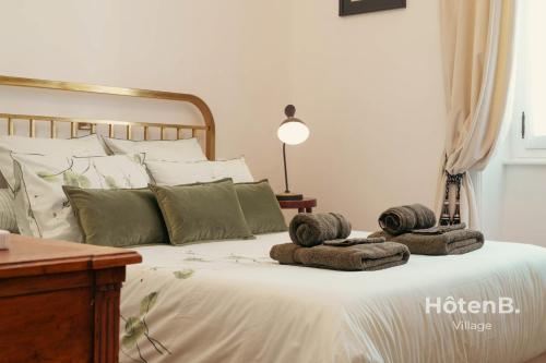 a bedroom with a bed with towels on it at "Les Effrontés" Louis Blanc Charming Apartment in Limoges