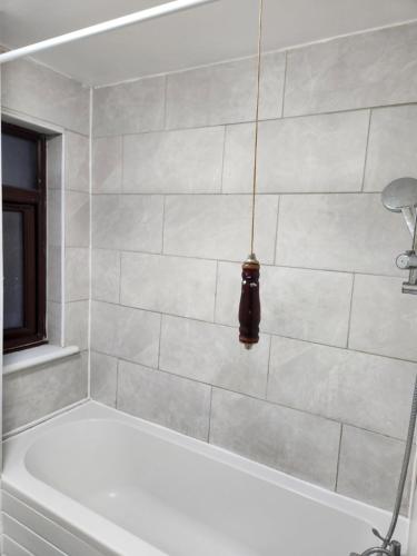 a white bath tub with a pendant light hanging over it at Tuscawilla 2 in Plumstead