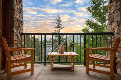 a table and two chairs on a balcony with a view at Mountain Lodge Telluride in Telluride